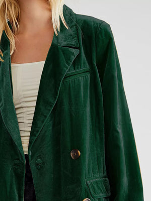 Green jacket worn by a person on a plain background