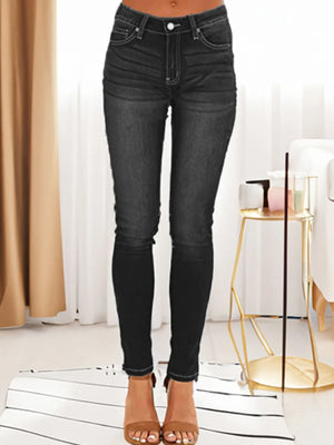 Black jeans worn by a person in a minimal indoor setting