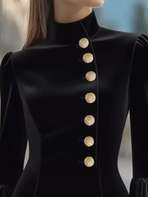 Black coat with gold buttons on a blurred background