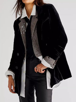 Person wearing a black coat with gray trim on a white background