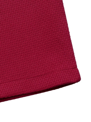 Close-up of a red fabric texture on a white background