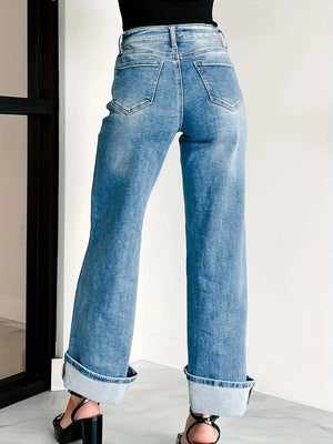 Blue jeans worn by a person on a white background