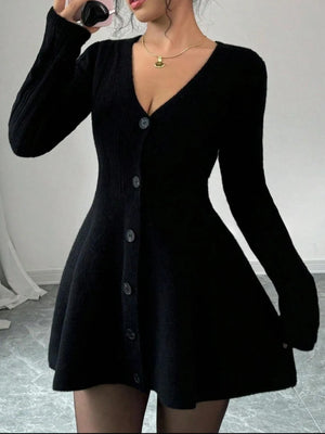 Black cardigan worn by a person against a plain background