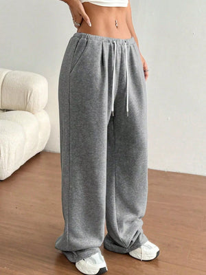 Person wearing gray sweatpants with a white background