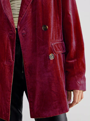 Red velvet coat with gold buttons on a plain background