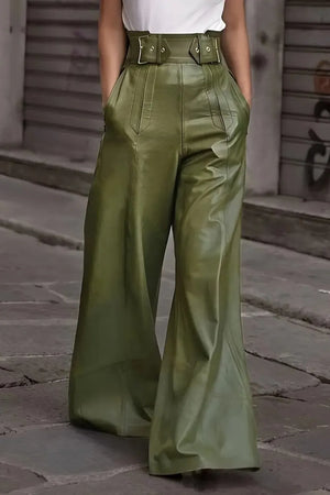 Person wearing green wide-leg pants on a street.