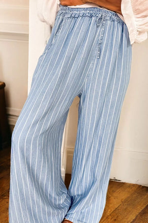 Blue and white striped pants worn by a person indoors.