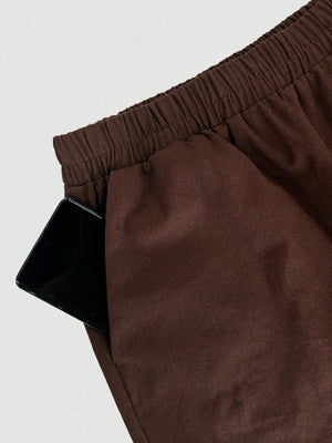 Brown pants with an elastic waistband on a light gray background