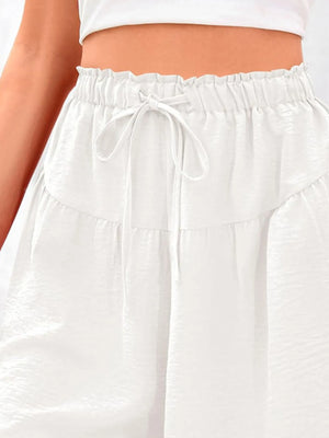 White pants with an elastic waistband worn by a person.