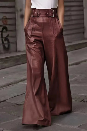 Person wearing brown wide-leg pants on a street background