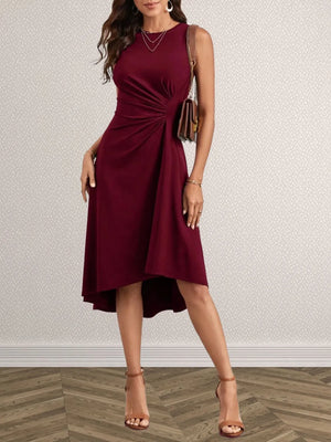 Woman wearing a burgundy dress with a plain background