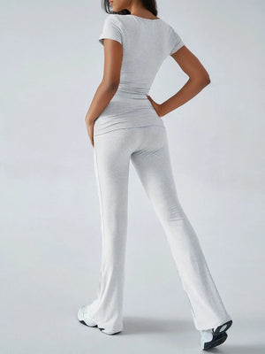 Person wearing a white outfit with a plain background