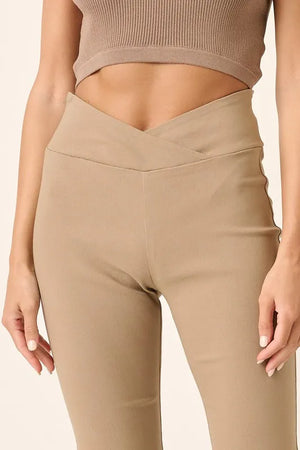 Beige leggings worn by a person on a beige background