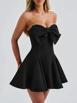 Black strapless dress with a large bow on a white background