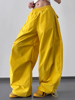 Yellow wide-leg pants worn by a person on a plain background