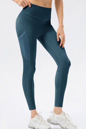 Teal leggings worn by a person on a white background