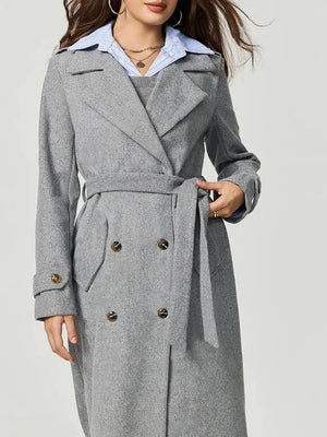 Gray coat with a belt worn by a person on a light gray background