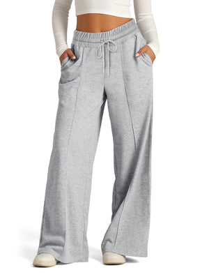 Gray sweatpants worn by a person on a white background