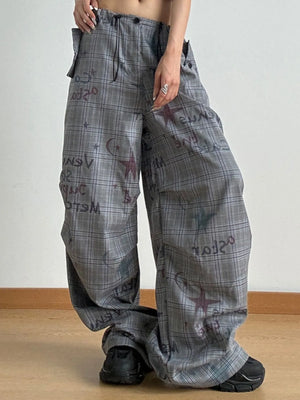 Person wearing plaid pants with text and star patterns on a plain background