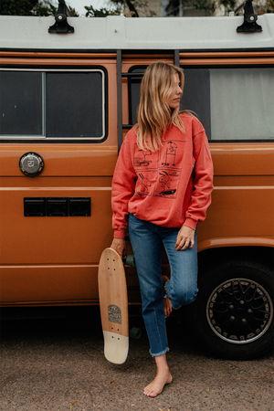 Girl holding a skateboard in front of a 60s van wearing Peanuts Joe Cool Snoopy Sweatshirt