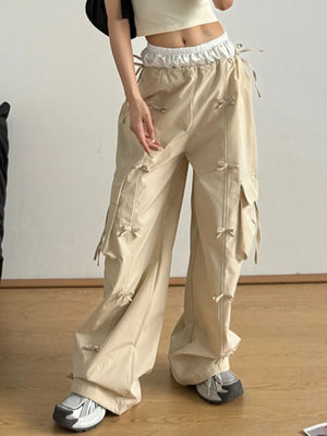 Person wearing beige cargo pants on a plain background