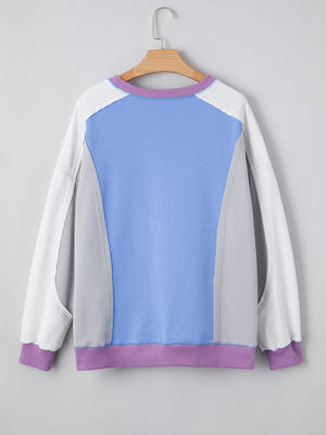 Color-blocked sweatshirt with blue and purple accents on a gray background