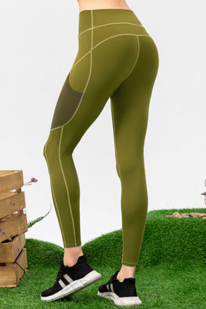Green leggings worn by a person on a grassy background