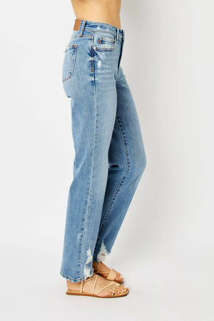 Blue jeans worn by a person on a white background
