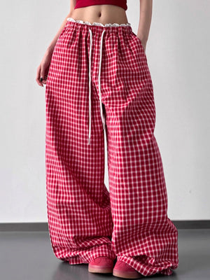 Red and white checkered pants worn by a person on a plain background