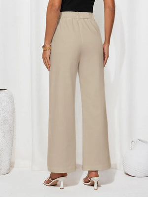 Beige wide-leg pants worn by a person on a white background