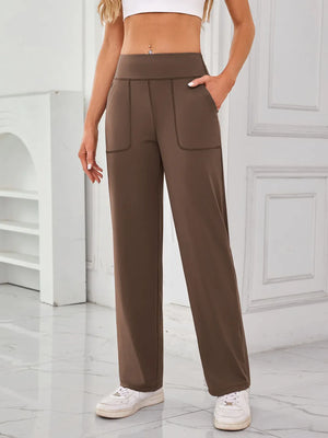 Brown wide-leg pants worn by a person in a minimal indoor setting