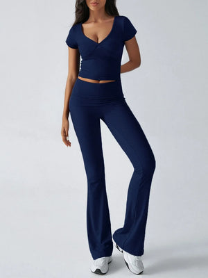 Woman wearing a navy blue outfit on a white background