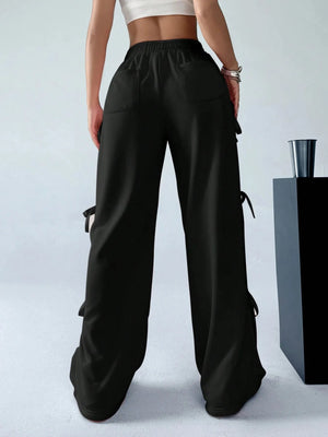 Black wide-leg pants worn by a person on a light gray background