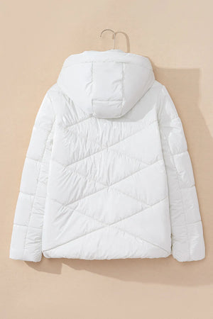 White puffer jacket on a beige background