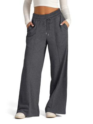 Gray sweatpants worn by a person on a white background