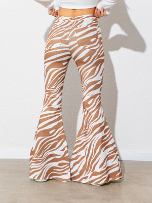 Zebra print bell-bottom pants worn by a person on a plain background