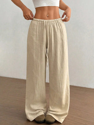 Beige wide-leg pants worn by a person on a plain background
