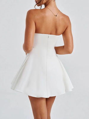 White strapless dress worn by a person on a plain background