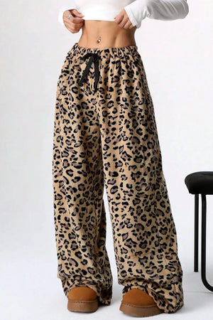 Leopard print pants worn by a person on a white background