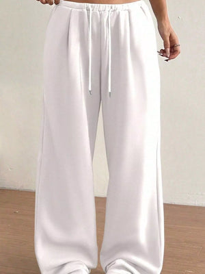 White wide-leg pants with a drawstring waist on a plain background
