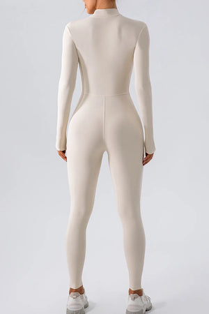 Person wearing a beige bodysuit on a white background