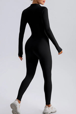 Person wearing a black bodysuit on a light gray background