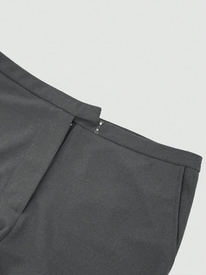 Close-up of a gray pleated skirt on a light gray background
