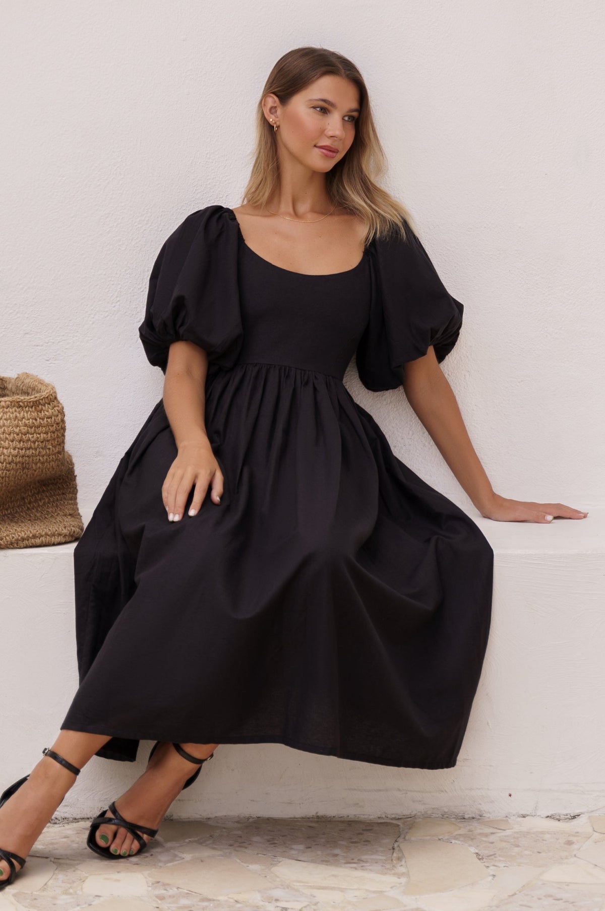 Model sitting showing view of Cherie Puff Sleeve Midi dress-black