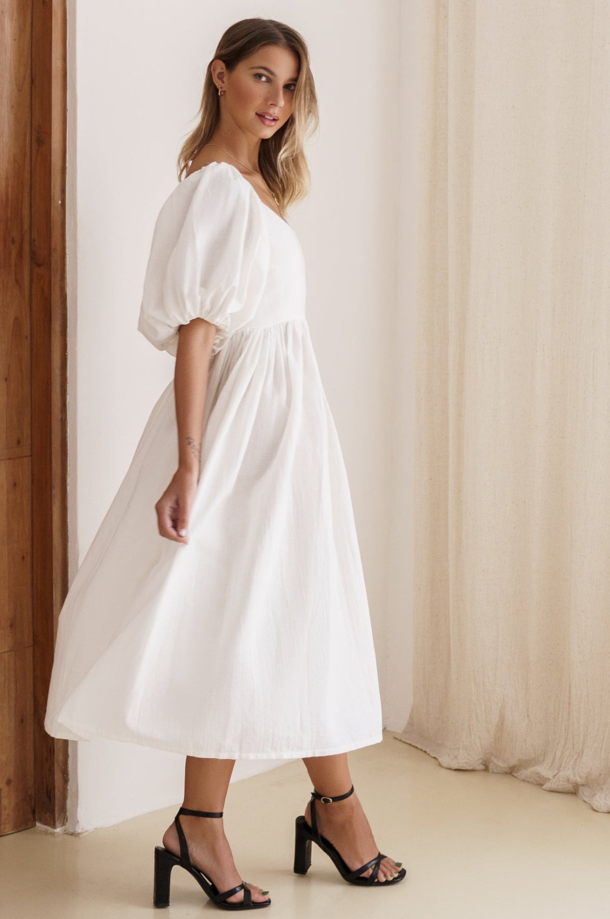 Left side view of Cherie Puff Sleeve Midi dress- white