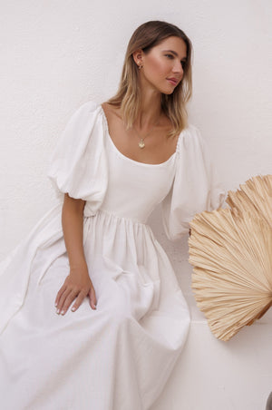 Woman sitting showing a view of Cherie Puff Sleeve Midi dress- white