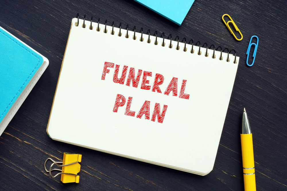 A note book with funeral plan written on it.