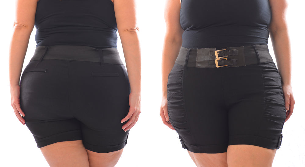 A woman in a black shirt and black shorts showing the front and back of the shorts