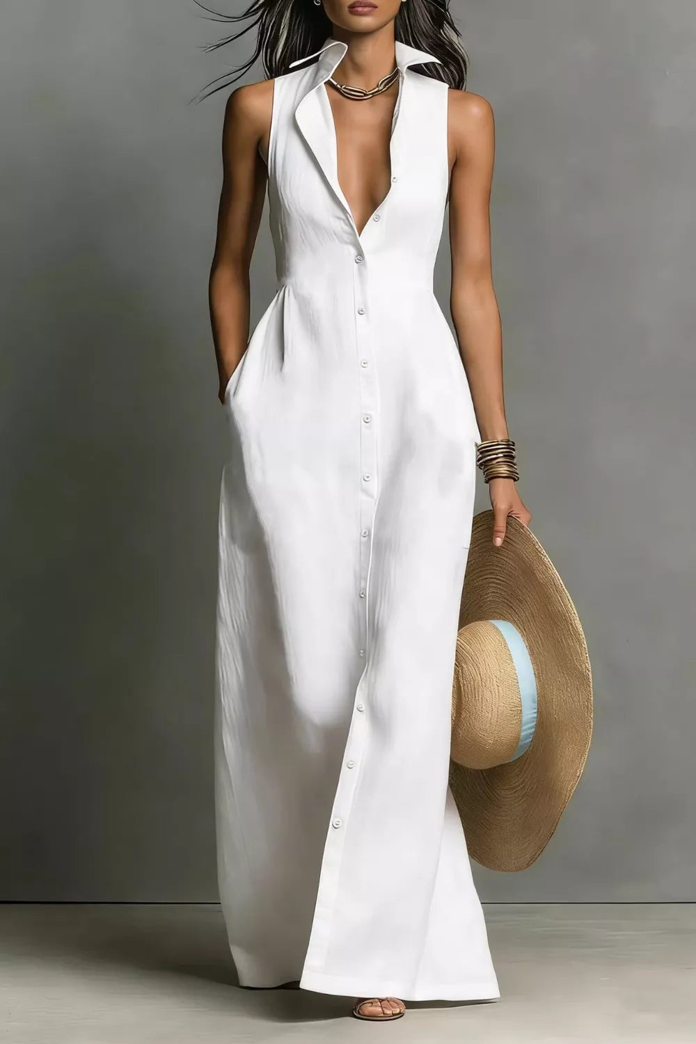 Woman wearing white dress carrying a hat