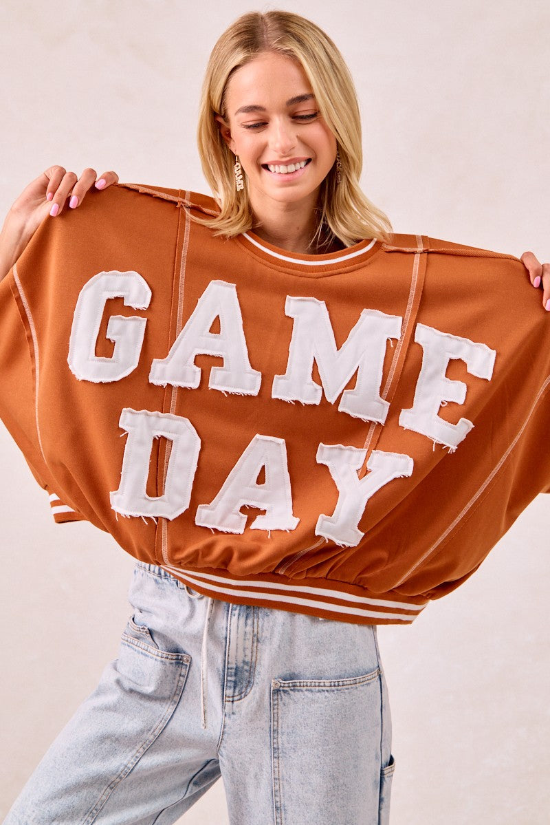 woman a brown game day sweatshirt